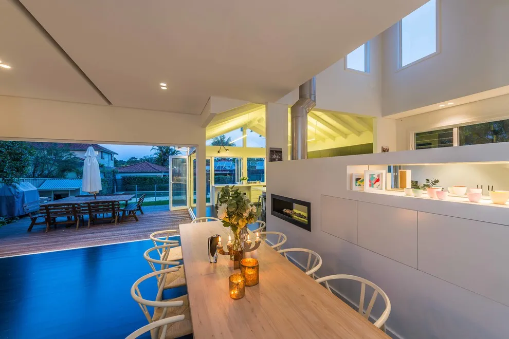 Open living and dining opening to a timber deck